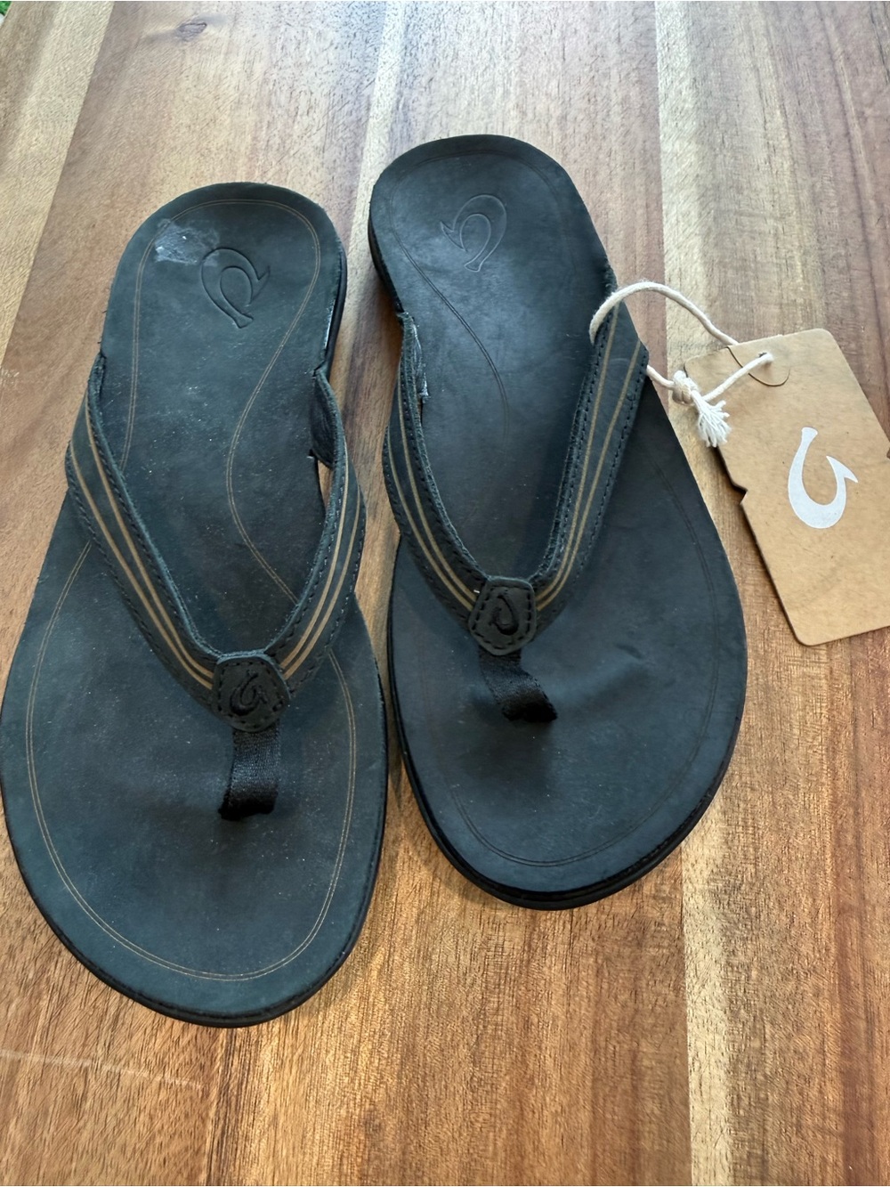 OluKai Black Thong Sandals with Subtle Tan Stripe